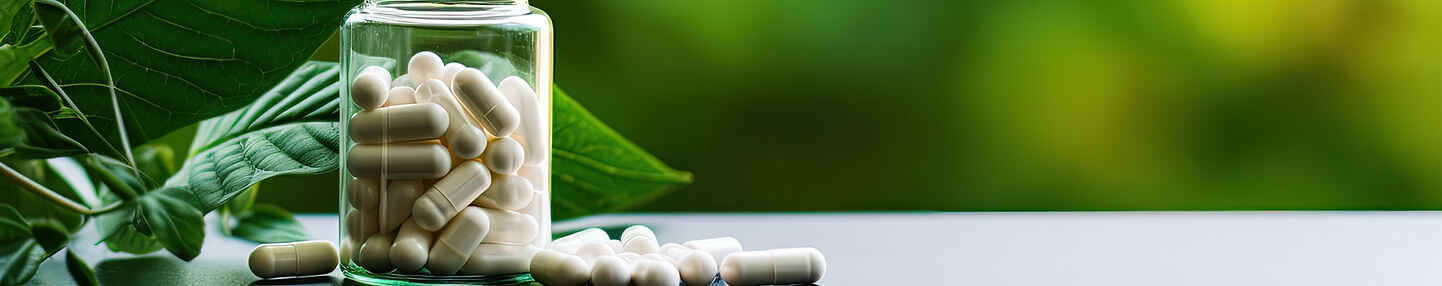 Private label supplement capsules in a jar next to a plant.